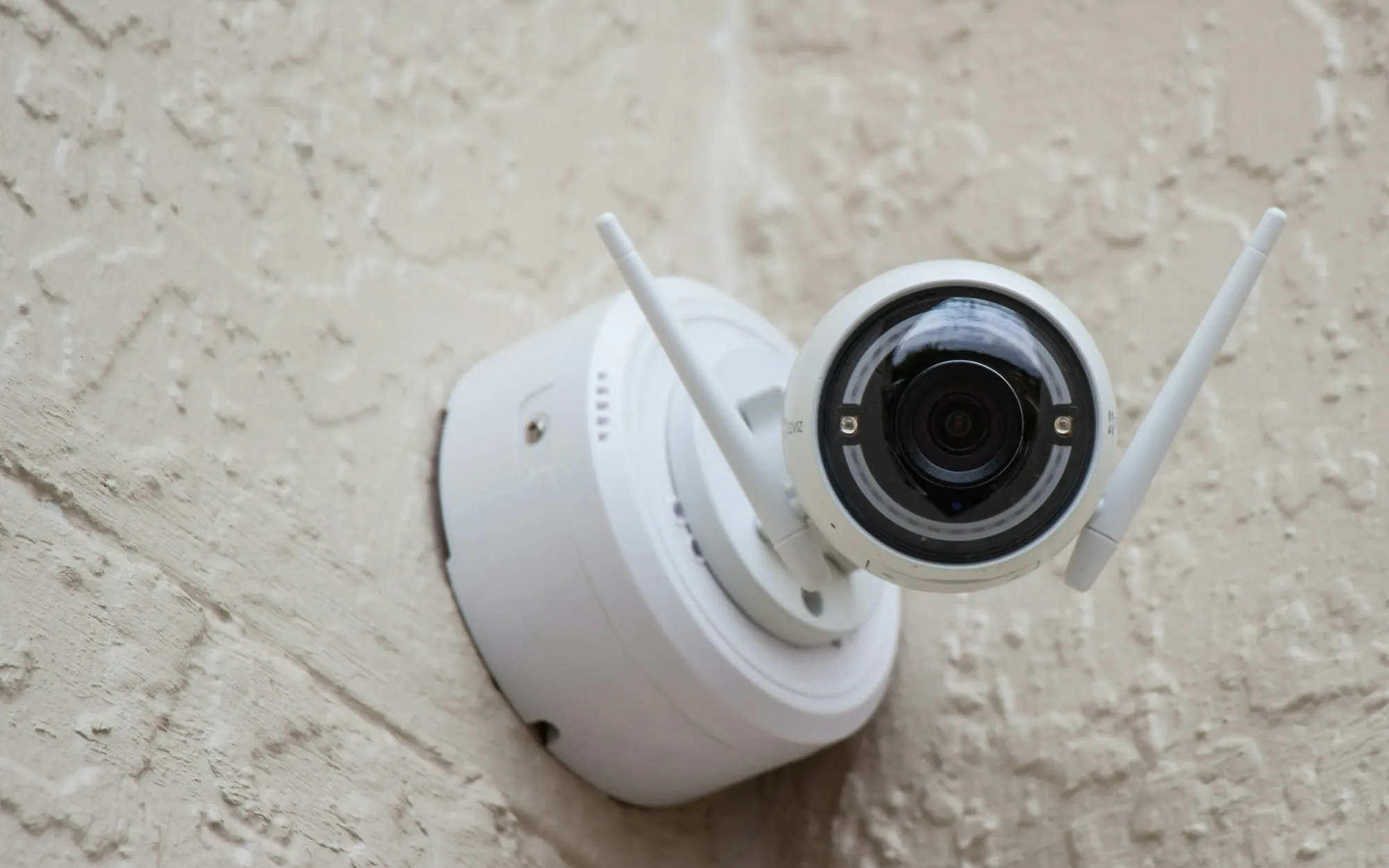 Security camera mounted on the outside wall of a home