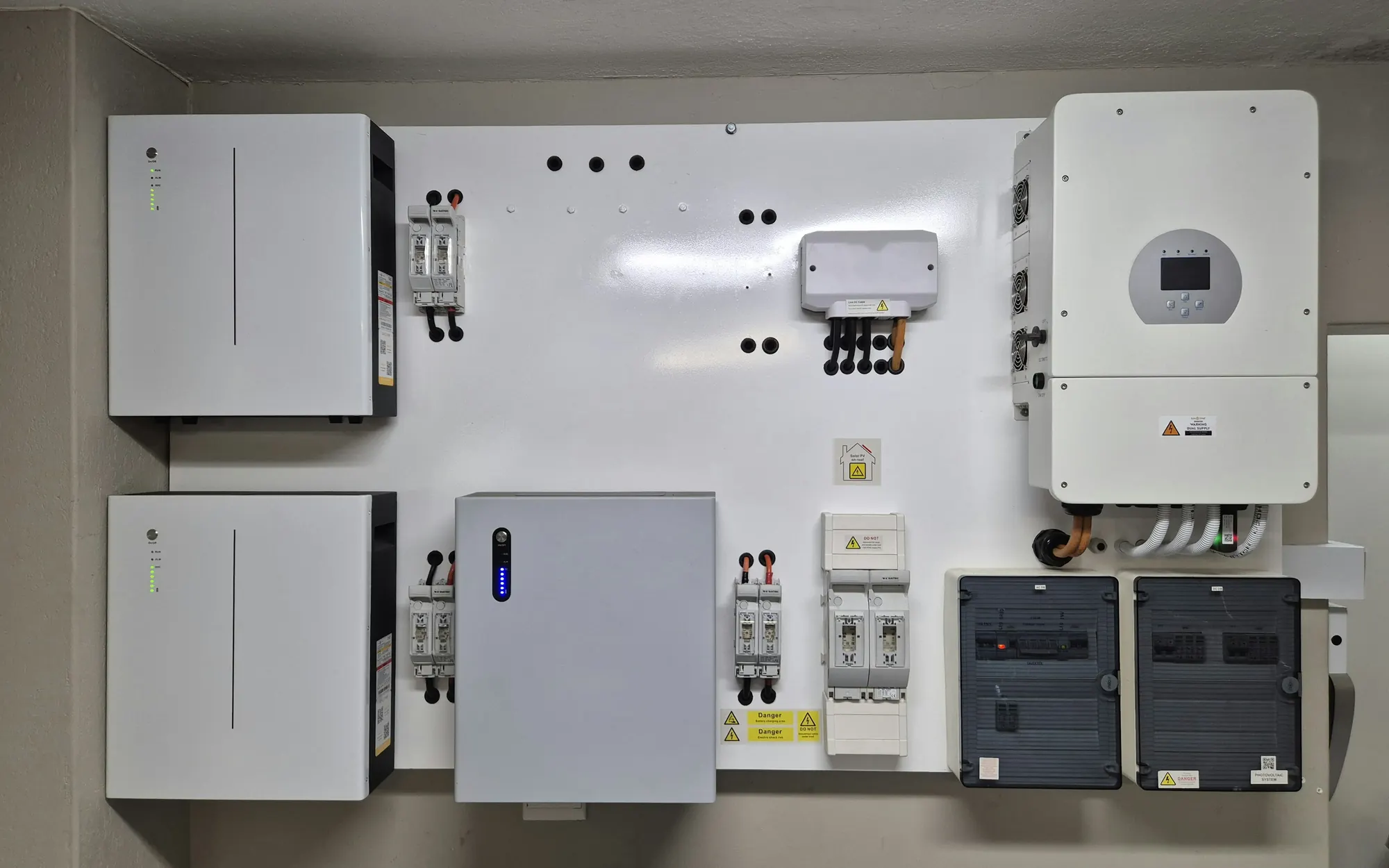 Home battery and inverter installed on a garage wall